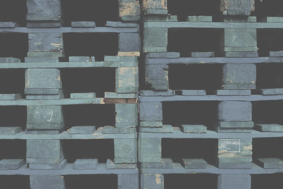 Stacked blue shipping pallets seen straight on